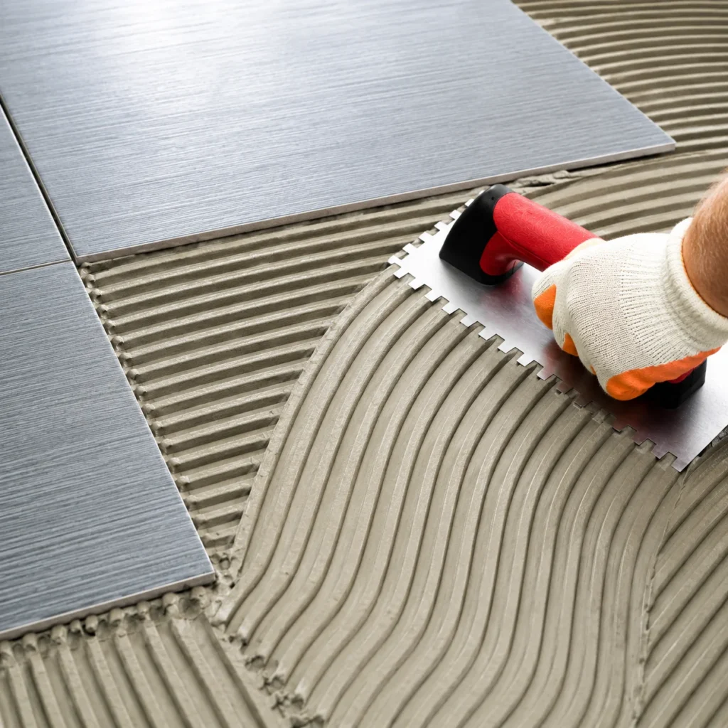 RDP for tile adhesive application showing ceramic tile installation with notched trowel and adhesive mortar